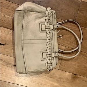A beige coach bag
